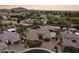 Aerial view of an estate with a stunning pool, grassy backyard, and views of mountain ranges at 3381 E Azalea Dr, Chandler, AZ 85286
