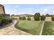 Beautiful backyard featuring an artificial putting green, lush landscaping, and hardscaped patio for relaxing and entertaining at 3381 E Azalea Dr, Chandler, AZ 85286