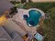 Aerial view of a backyard with a pool, spa, putting green, lounge area, and outdoor fireplace at 3381 E Azalea Dr, Chandler, AZ 85286