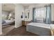 Bright bathroom with wood cabinets, stylish tub and large, illuminated mirror connected to main bedroom at 3381 E Azalea Dr, Chandler, AZ 85286