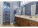 Bathroom showcasing double sinks, decorative towels, white cabinets, and uniquely patterned shower curtain at 3381 E Azalea Dr, Chandler, AZ 85286