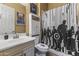 Charming bathroom features a vanity, a matching cabinet, toilet, and a Marvel-themed shower curtain at 3381 E Azalea Dr, Chandler, AZ 85286