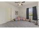 Spacious carpeted room with a window, dark curtains, and quirky decorative accents at 3381 E Azalea Dr, Chandler, AZ 85286