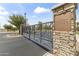 View of Layton Lakes community entrance sign, featuring stone pillars and metal gate at 3381 E Azalea Dr, Chandler, AZ 85286