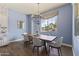 Charming dining room featuring a modern chandelier, and natural light with views of the outdoor landscaping at 3381 E Azalea Dr, Chandler, AZ 85286