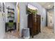 Hallway view features TV, dresser, and access to a study space, highlighting the home's layout at 3381 E Azalea Dr, Chandler, AZ 85286