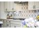 Close up view of the kitchen shows elegant backsplash, countertops, and cooktop at 3381 E Azalea Dr, Chandler, AZ 85286