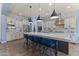 Gourmet kitchen boasts a large island with seating, stylish pendant lighting, and stainless steel appliances at 3381 E Azalea Dr, Chandler, AZ 85286
