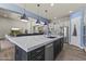 Kitchen island with stylish pendant lighting, seating, and stainless steel appliances at 3381 E Azalea Dr, Chandler, AZ 85286