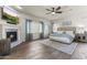 Spacious main bedroom featuring a fireplace, ceiling fan, and beautiful hard wood floors at 3381 E Azalea Dr, Chandler, AZ 85286