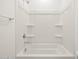 Clean bathtub and shower area with chrome fixtures and built-in soap shelves at 37458 W San Clemente St, Maricopa, AZ 85138
