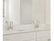 Clean bathroom featuring a double sink vanity with sleek chrome faucets and a large mirror at 37458 W San Clemente St, Maricopa, AZ 85138