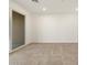 Bright, spacious bedroom with tile floors, neutral walls, and a sliding glass door that fills the room with light at 37458 W San Clemente St, Maricopa, AZ 85138