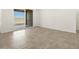 Spacious bedroom featuring tile flooring, sliding glass door to backyard, and neutral decor at 37458 W San Clemente St, Maricopa, AZ 85138