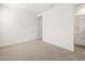 Bright bedroom with neutral carpet, leading to the bathroom entrance at 37458 W San Clemente St, Maricopa, AZ 85138