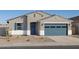 Charming single-story home featuring a blue garage door, shuttered window and neutral stucco at 37458 W San Clemente St, Maricopa, AZ 85138