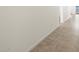 A well-lit hallway featuring neutral tile flooring and a fresh, modern aesthetic at 37458 W San Clemente St, Maricopa, AZ 85138
