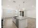 Open kitchen featuring a large island with granite countertops and modern appliances at 37458 W San Clemente St, Maricopa, AZ 85138