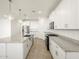 Bright modern kitchen with white cabinets, an island, stainless appliances, and granite counters at 37458 W San Clemente St, Maricopa, AZ 85138