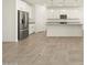 Modern kitchen with stainless appliances, a center island, and granite countertops at 37458 W San Clemente St, Maricopa, AZ 85138