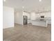 Bright kitchen featuring white cabinetry, granite countertops, and stainless appliances at 37458 W San Clemente St, Maricopa, AZ 85138