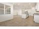 Open-concept living space featuring tile flooring, modern kitchen with stainless steel appliances and island at 37458 W San Clemente St, Maricopa, AZ 85138