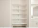A wall of adjustable white shelves provides ample storage and organization at 37458 W San Clemente St, Maricopa, AZ 85138