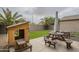 Spacious backyard with artificial turf, playhouse, picnic table and desert trees at 3795 W Mercury Way, Chandler, AZ 85226