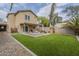 Large backyard with artificial turf, fire pit, picnic table and covered patio at 3795 W Mercury Way, Chandler, AZ 85226