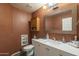 Cozy bathroom with vanity, mirror, toilet, and recessed lighting, creating a warm and inviting space at 3795 W Mercury Way, Chandler, AZ 85226