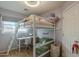 Charming bedroom featuring a loft bed with built-in desk and a cozy seating area at 3795 W Mercury Way, Chandler, AZ 85226