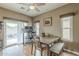 Bright dining area boasts wood floors, windows, sliding patio door, and decorative table and bench at 3795 W Mercury Way, Chandler, AZ 85226