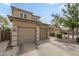 Attached two-car garage and wide driveway offering convenient parking on this modern home exterior at 3795 W Mercury Way, Chandler, AZ 85226