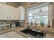 Bright kitchen featuring white cabinets, tile backsplash, and a black sink with goose neck faucet at 3795 W Mercury Way, Chandler, AZ 85226