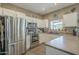 Bright kitchen features white cabinets, stainless steel appliances, and tile backsplash at 3795 W Mercury Way, Chandler, AZ 85226