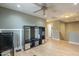 The open concept living space has laminate flooring, a ceiling fan and an entertainment center that fills the room with light at 3795 W Mercury Way, Chandler, AZ 85226