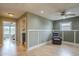 A stylish living area has wainscotting, laminate flooring, and is naturally lit via a window and an open doorway at 3795 W Mercury Way, Chandler, AZ 85226