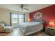 Spacious primary bedroom with a large window, soft lighting, and a cozy chair, creating a serene retreat at 3795 W Mercury Way, Chandler, AZ 85226