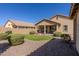 Private backyard features a covered patio, desert landscaping, and artificial turf at 40707 W Pryor Ln, Maricopa, AZ 85138
