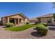 Well-maintained backyard with artificial turf, desert landscaping, and a covered patio at 40707 W Pryor Ln, Maricopa, AZ 85138