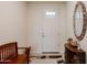 Inviting foyer with a white door, tiled floors, and decorative furnishings at 40707 W Pryor Ln, Maricopa, AZ 85138