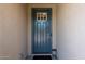 Stylish blue front door with decorative window and modern hardware at 40707 W Pryor Ln, Maricopa, AZ 85138