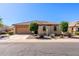 Charming single-story home featuring a tile roof, well-manicured front yard, and a two-car garage at 40707 W Pryor Ln, Maricopa, AZ 85138