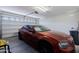 Garage with an orange car and garage door at 40707 W Pryor Ln, Maricopa, AZ 85138