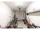 Clean garage features overhead storage, garage door, and ample room for storage at 40707 W Pryor Ln, Maricopa, AZ 85138