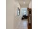 Hallway with a view of a well-lit office and a grandfather clock at 40707 W Pryor Ln, Maricopa, AZ 85138