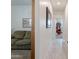Hallway with a view of a well-lit living room and a grandfather clock at 40707 W Pryor Ln, Maricopa, AZ 85138