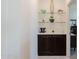 Hallway with storage cabinets, shelving, and decorative glass art at 40707 W Pryor Ln, Maricopa, AZ 85138