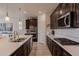 Well-appointed kitchen featuring an island with a sink, modern appliances, and abundant counter space at 40707 W Pryor Ln, Maricopa, AZ 85138