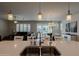 Bright kitchen island with stainless sink and faucet overlooking an open floor plan at 40707 W Pryor Ln, Maricopa, AZ 85138